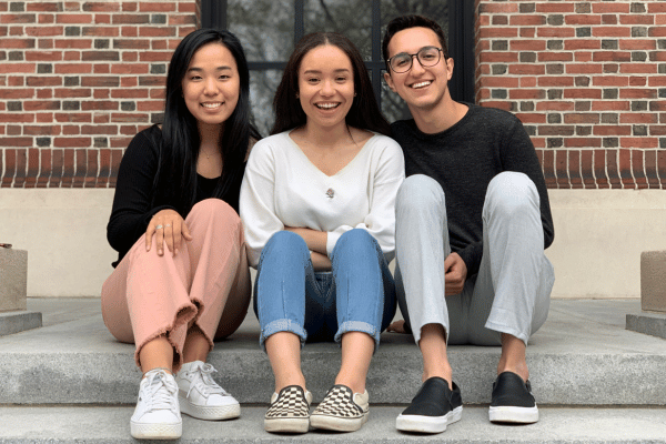 Image of three youth orchestra members sitting down, showing Youth Orchestras Opportunity Structures