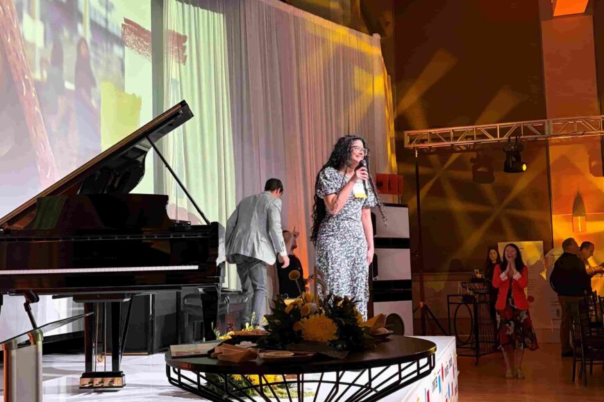 Young woman standing on a podium presenting