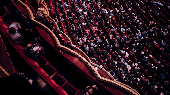 Image of an orchestra hall with the audience sitting