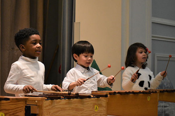 Image of children playing in music class.