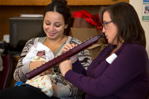 A mother and child with musician during a Lullaby Project session.